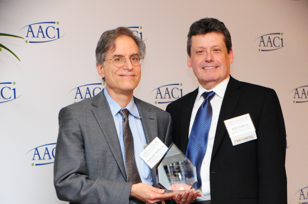 Arnold Rabson, M.D., left, accepts the Special Recognition Award from AACI, on behalf of his father, Alan S. Rabson, M.D.