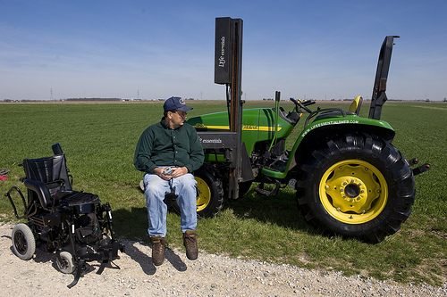 NIFA’s AgrAbilty Project recipient uses modified lift to transfer from wheelchair to tractor.  Photo credit:  National AgrAbility Project at Purdue University.