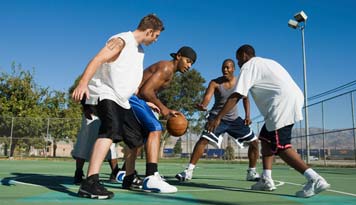 Photo of a group of guys playing a game of basketball