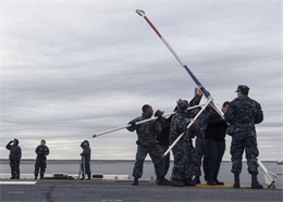 Sailors aboard the USS Bataan (LHD 5) at Naval Station Norfolk, Va., take down a flag pole while leaving port, Dec. 10, 2012. The Sailors will be conducting training with Marines and sailors of the 26th Marine Expeditionary Unit during the third major training exercise of their pre-deployment training exercise. (U.S. Marine Corps Photo by Cpl. Kyle N. Runnels/Released)