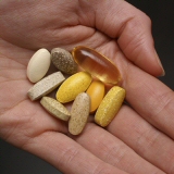 Hand holding supplement pills