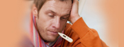 Diseases and Conditions: Closeup of a sick man with a thermometer in his mouth