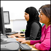 Two women using computers