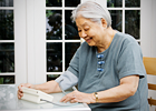 An elderly woman checks her blood pressure
