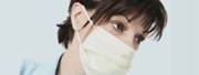 Employee Health: Closeup of a medical professional with a surgical mask over here face