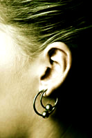 An ear with two earrings in it.