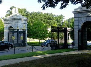 Cars entering the cemetery through a gate