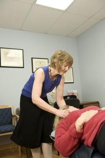 A chiropractor works on a patient.