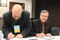 Tim Mattick (left), president of the Montana Grain Elevators Association, signs the alliance documents along with Jeff Funke, director of OSHA's Billing Area Office. View the slideshow for more images and captions.