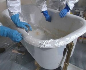 Nitrile-gloved hands refinishing a bathtub