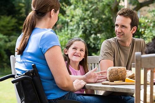 Family of three dines outdoors. ERS research found that among households that included an adult with a work-preventing disability, a third were food insecure in 2009-10.