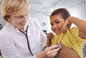 Doctor Using a Stethoscope on Little Boys Chest