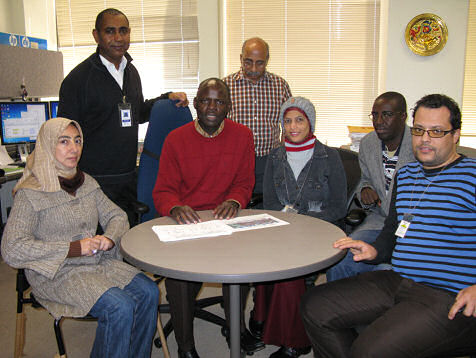 CPC African Desk Coordinator Wassila Thiaw leading a climate discussion with African Desk staff and trainees.  Seated from left to right: Amira Ibrahim, Awatif Mostafa, Aaron Ntiranyibagira, and Lotfi Khammari. Standing: Endalkachew Bekele and Vadlamani Kumar.
