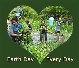 Heart shaped photo of students in water, pulling up plants.  Text reads Earth Day Every Day