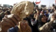 An Egyptian holds a piece of bread to protest against the high prices of goods in Tahrir Square in Cairo, February 8, 2013. 