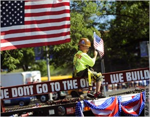 Hunter Ribarchak, 7, rides on the Iron Workers of America's float during the 2008 Labor Day Parade in Pittsburgh, Pennsylvania.