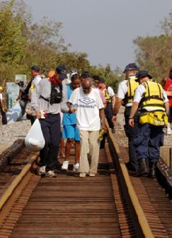 Volunteers walking along railroad tracks