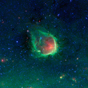 This glowing emerald nebula seen by NASA's Spitzer Space Telescope is named RCW 120; this region of hot gas and glowing dust can be found in the murky clouds encircled by the tail of the constellation Scorpius.