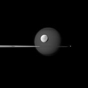 A quartet of Saturn's moons, from tiny to huge, surround and are embedded within the planet's rings in this Cassini composition. Saturn's largest moon, Titan, in the background, and the moon's north polar hood is clearly visible.