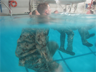 Marines float and tread water during their swim qualification in the Ramer Hall pool at The Basic School on Feb. 4. Marines are able to tread water or use their blouse or trousers as a floatation device.