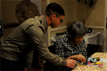 Lance Corporal Ryan Phillips delivers a single rose to a resident of the River Oaks Assisted Living for Valentine