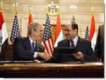 Date: 12/14/2008 Location: Baghdad, Iraq Description: President George W. Bush and Iraqi Prime Minister Nuri al-Maliki shake hands following the signing of the Strategic Framework Agreement and Security Agreement at a joint news conference Sunday, Dec. 14, 2008, at the Prime Minister