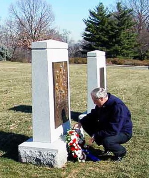 A visitor placing a wreath at the Challenger Memorial