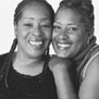 Sisters Joan and Bonnie, who have been personally affected by heart disease, pose and smile together.
