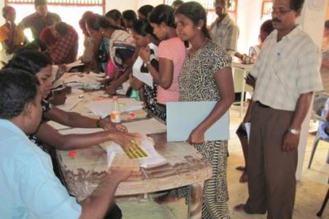 Displaced Sri Lankan citizens apply for replacement identity documents at a USAID-funded mobile clinic. 