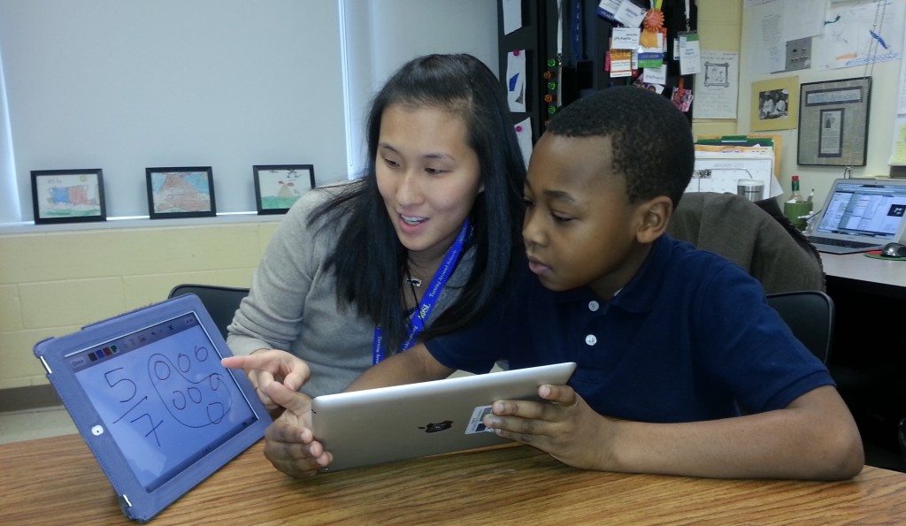 Teacher and student work together using technology