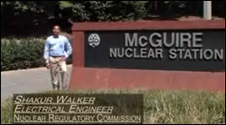 photo showing U.S. NRC employee standing next to the McGuire Nuclear Station sign for a U.S. Government employment video