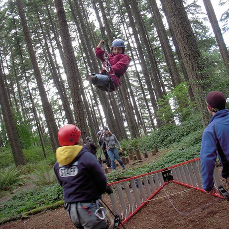 Azima on a ropes course with Mobility International USA in Eugene, OR