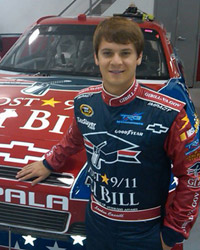 Landon standing in front of his Nascar