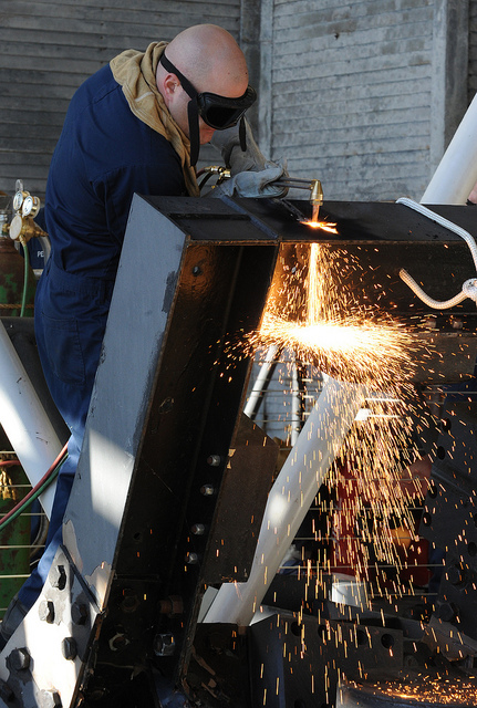 Image description: U.S Navy Hull Maintenance Technician 3rd Class Alex Grothjan cuts through a ferry slip brace damaged by Hurricane Sandy at Hoboken Transit Terminal, N.J.
Photo by: Mass Communication Specialist 1st Class James Stenberg, U.S. Navy