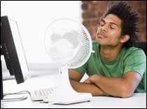 Photo of young man in front of fan.