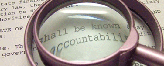 Image of a magnifying glass over the word 'accountability'