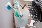 Two toothbrushes and a hairbrush.   - Click to enlarge in new window.