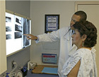 A woman looking at her x-rays with her doctor. - Click to enlarge in new window.