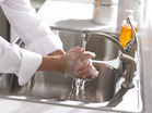 A woman washing her hands.  - Click to enlarge in new window.