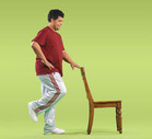 Demonstration of standing on one foot while balancing on a chair. - Click to enlarge in new window.