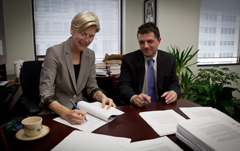 Professor Elizabeth Warren and Assistant Director for Large Bank Supervision Steve Antonakes sign introductory letters to the CEOs of over 170 financial institutions that are subject to CFPB Supervision.
