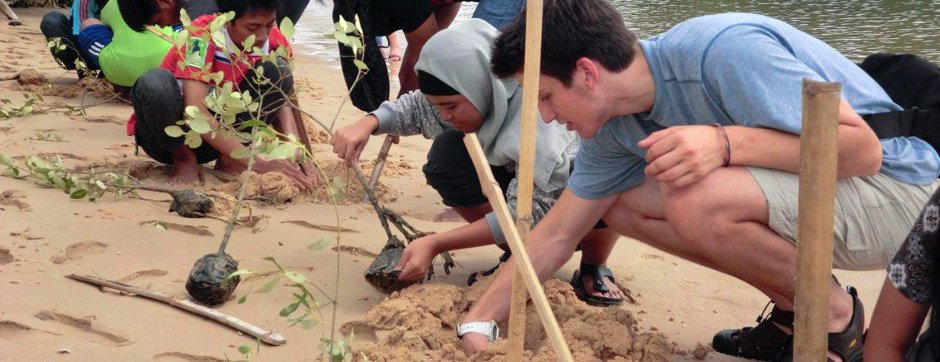 Justin, of Connecticut, plants mangroves with Indonesian students.