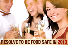 Group of young people celebrating New Year's eve. TEXT: Resolve to Be Food Safe in 2013