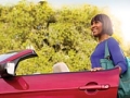 Woman standing next to car, discount on AARP's Driver Safety online course