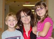 Victoria Reyes, Library Technician, oversees the 'Kids Corner' for the dependents of OEF/OIF veterans. With her are Robby and Miranda. Items in the 'Kids Corner' are donated by the Jewish War Veterans