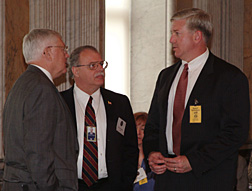 John Grimes (left), Raytheon Company’s Vice President for Command, Control, Communications and Intelligence - Washington Operations, chats with the President’s former Cyberspace Security Advisor Howard Schmidt (center) and Robert Stephan, Special Assistant to the Department of Homeland Security’s Under Secretary for Information Analysis and Infrastructure Protection (IAIP)