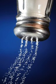A photo of an inverted salt shaker pouring out salt