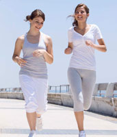 Two women running outside.