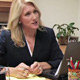 Woman handing paper across desk