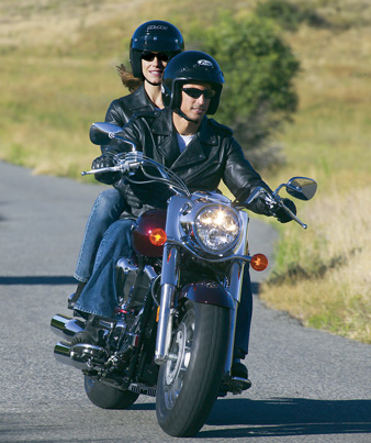 man and woman riding motorcycle